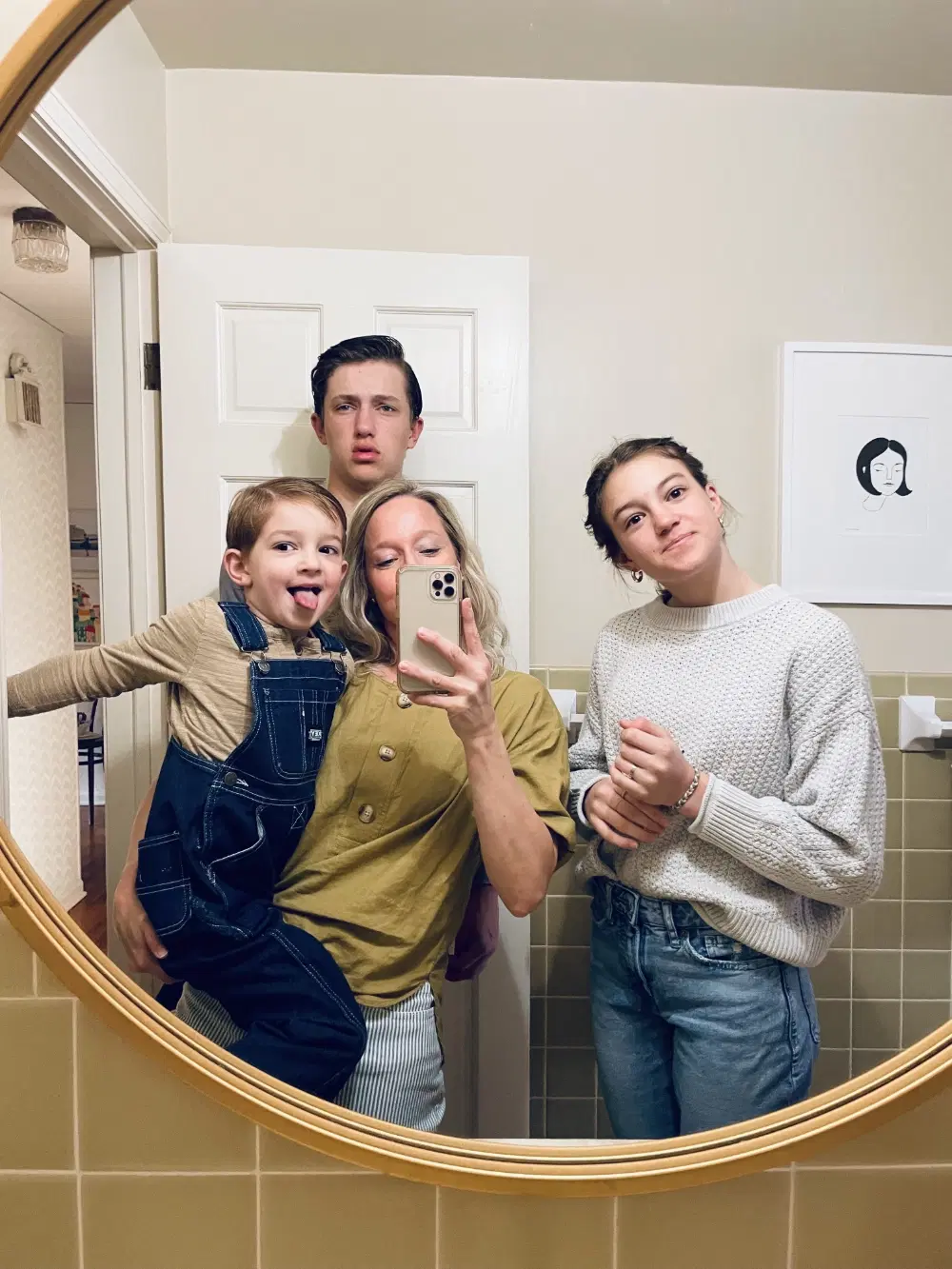 Child writing on a note surrounded by printed photos
